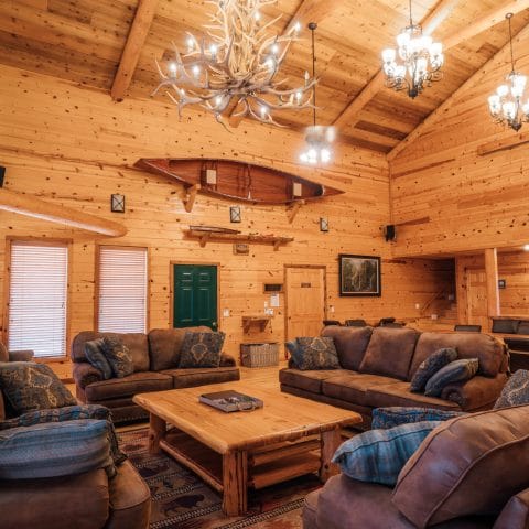 The RiverWind Lodge Great Room with its appointments of rustic elegance and a view across Arkansas's prettiest place.