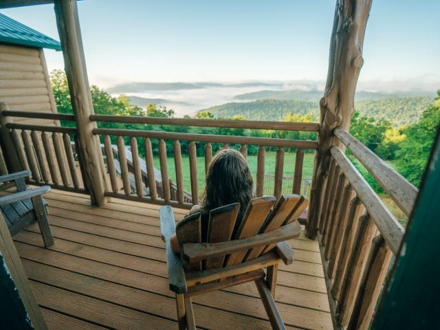 A woman takes in the view from one of the Riverwind Lodge balcony's.